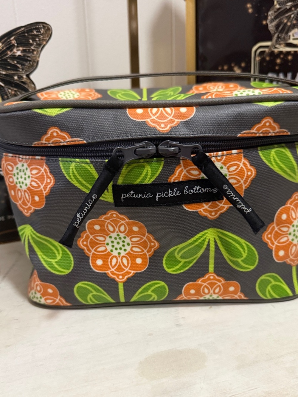 Petunia Pickle Bottom Gray Cosmetic Case with Orange Floral & Green Leaves
